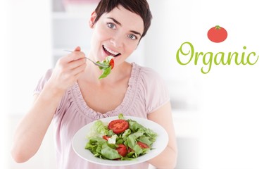 Organic against goodlooking woman eating salad