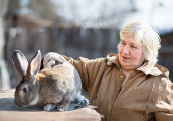 elderly woman with a big rabbit