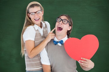 Composite image of excited geeky hipster and his girlfriend