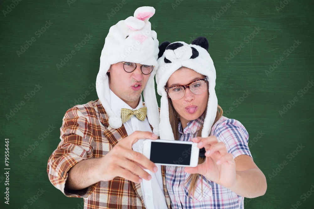 Poster geeky hipster couple taking selfie with smartphone