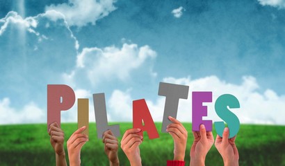 Composite image of hands holding up pilates © WavebreakMediaMicro