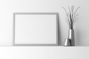 blank gray photo frame on white shelf