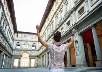 Young woman near uffizi gallery rejoicing in florence, italy