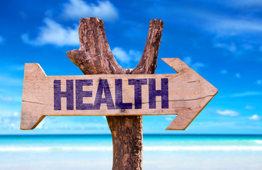 Health wooden sign with beach background