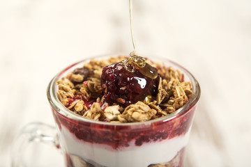 Musli on yogurt coverd with fruits and honey