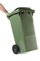 Male hand pushing green garbage bin