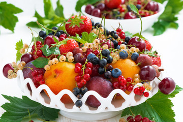 dish with fresh seasonal fruit and berries, close-up