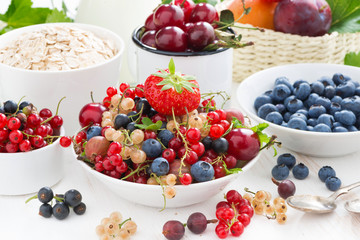 fresh berries, fruit, cereal and milk for breakfast