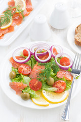 salad with salted salmon, top view, close-up