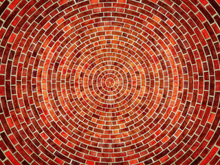 Radial red brick wall texture pattern.
