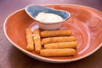 Deep fried breaded cheese sticks with tartar sauce
