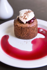 Dessert with chocolate sponge cake, cherry and vanilla ice cream