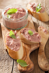 healthy chicken liver pate with sage in jar and on bread