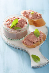healthy chicken liver pate with sage in jar and on bread