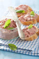 healthy chicken liver pate with sage in jar and on bread