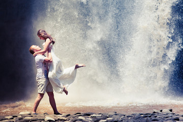 couple travel near the waterfall