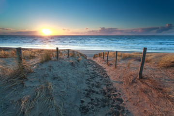 path no North sea beach at sunset