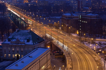 Fototapeta na wymiar Movement of cars on night street in Warsaw in winter