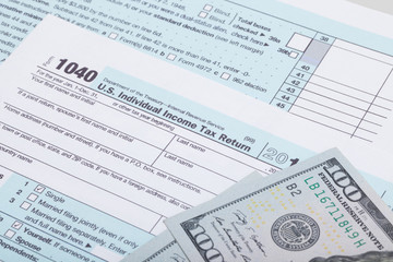 US 1040 Tax Form and dollars - studio shot