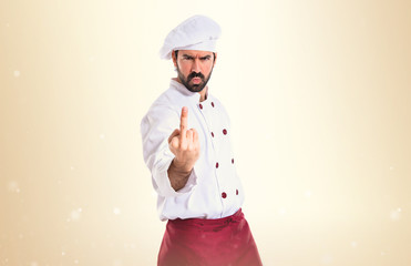 Chef making horn gesture over white background