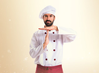 Chef making time out gesture over white background