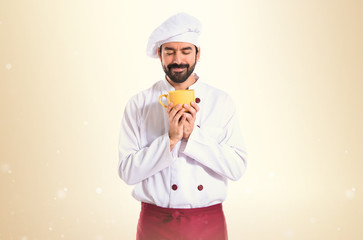 Chef holding a cup of coffee over white background