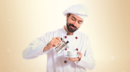 Chef holding a cup of coffee over white background