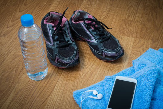 Sport equipment. Sneakers, water , earphones, smart phone