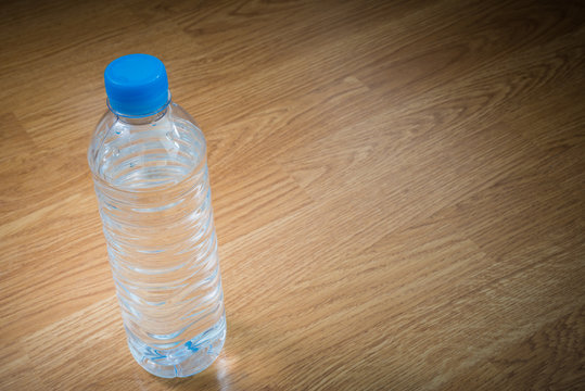 plastic water bottle on the wooden table