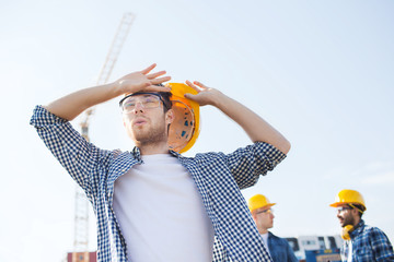 group of builders in hardhats outdoors