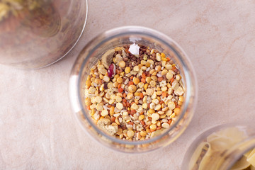 glass jar with seeds, corn, beans, pasta