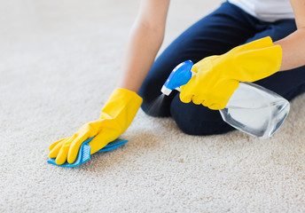 close up of woman with cloth cleaning carpet