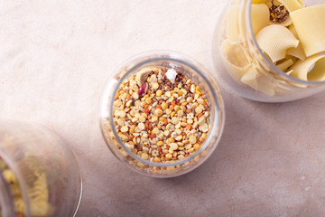 glass jar with seeds, corn, beans, pasta