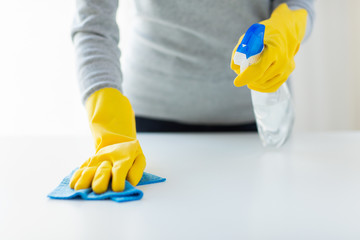 close up of woman cleaning table with cloth