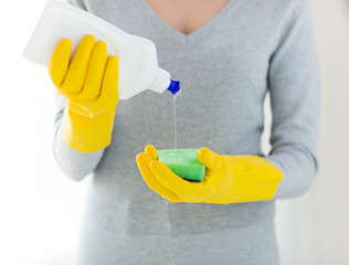 close up of woman with sponge and cleanser