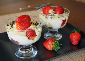 Dessert vanilla pudding with fresh strawberries