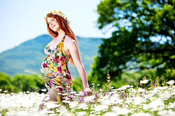 Beautiful pregnant woman relaxing in forest