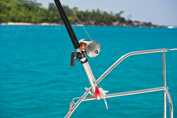 Fototapeta na wymiar Fishing rod and reel on a boat