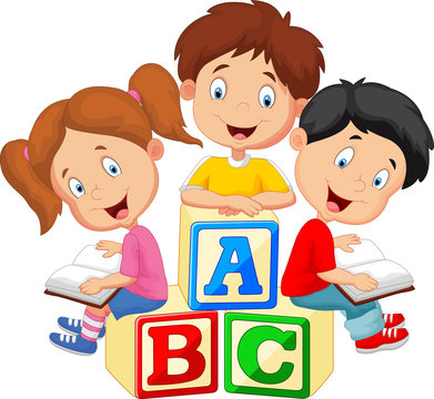 Children reading book and sitting on alphabet blocks
