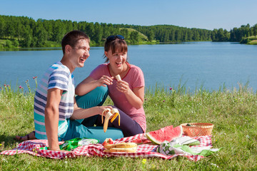 Couple in love at a picnic at the lake