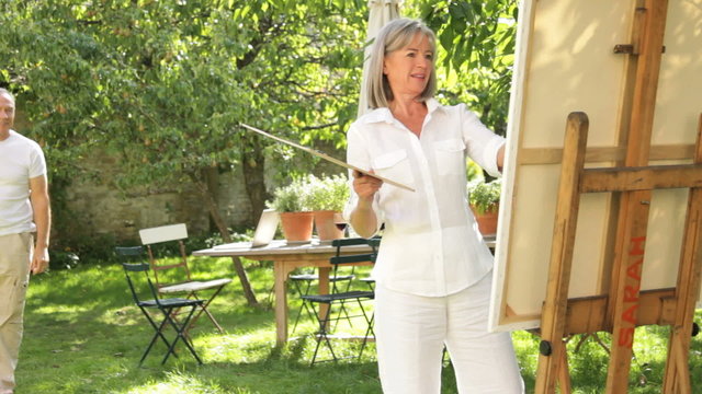 Mature couple in garden painting