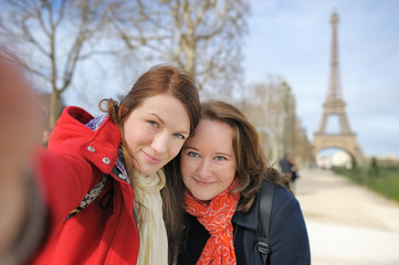 Two woman taking selfie near the Eiffel tower