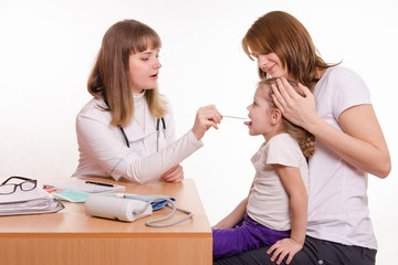 Pediatrician looking into throat of child sitting on lap