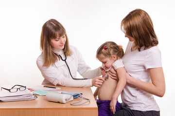 Pediatrician listening to baby's breath stethoscope