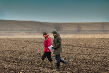 Farmers on plowed field