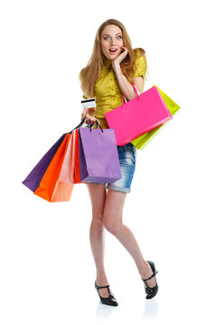 Happy caucasian woman with shopping bags and holding credit card