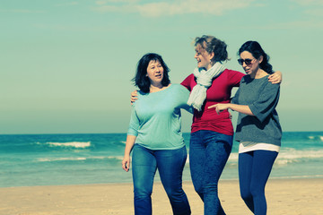 Three best friends walking at seaside