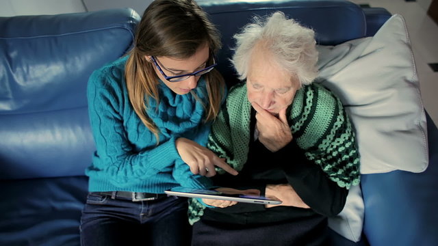 Granddoughter enjoys showing his grandmother how to use the new Tablet PC