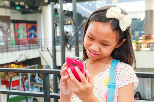 Asian child girl using smartphone