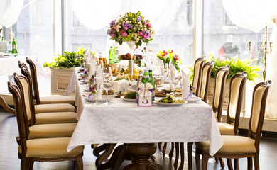decorated table ware glass glasses and fresh flowers